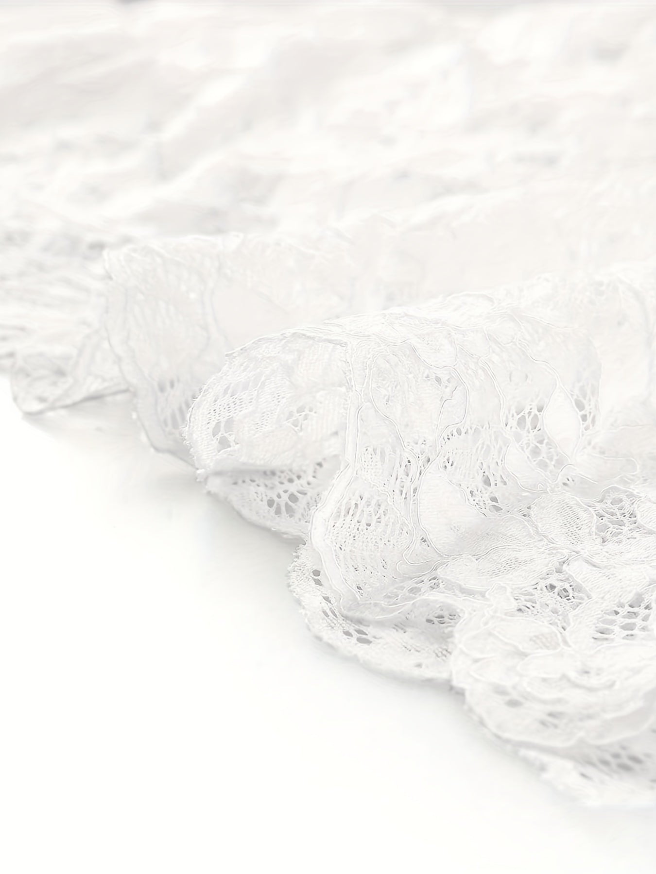 Halvtransparent cropped cardigan med blommig spets