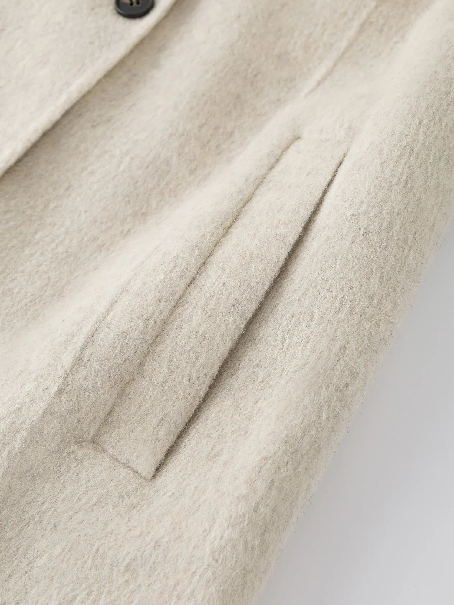 Liten dubbelsidig ullkappa